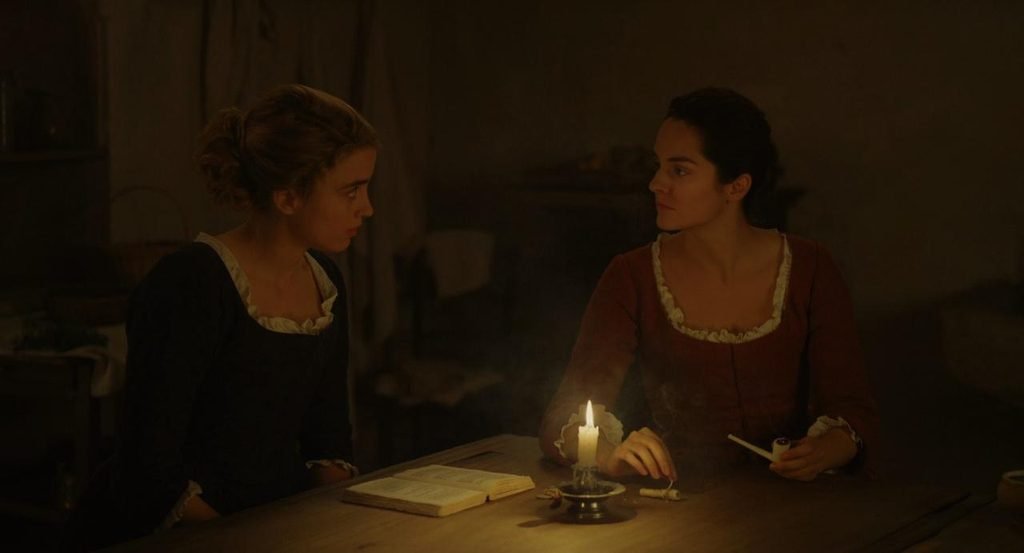 Marianne and Héloïse in a candlelit room in Portrait of a Lady on Fire