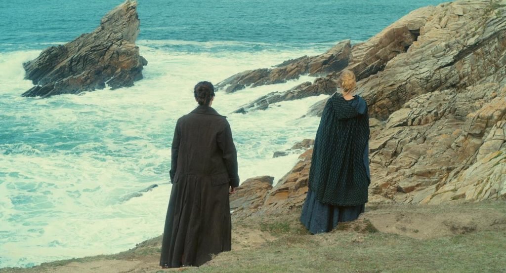 Héloïse and Marianne walking along the coast in Portrait of a Lady on Fire